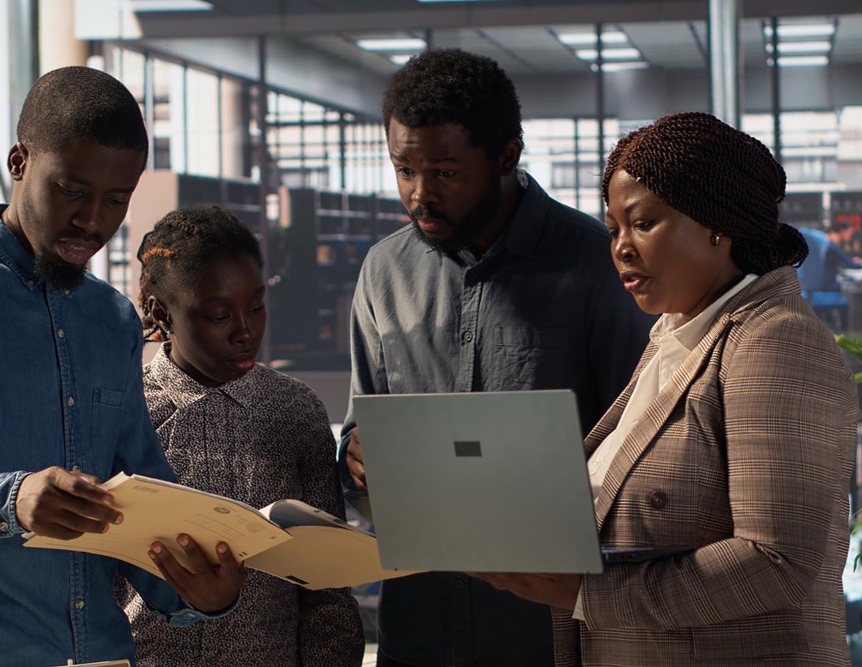A team working through documents and a laptop together