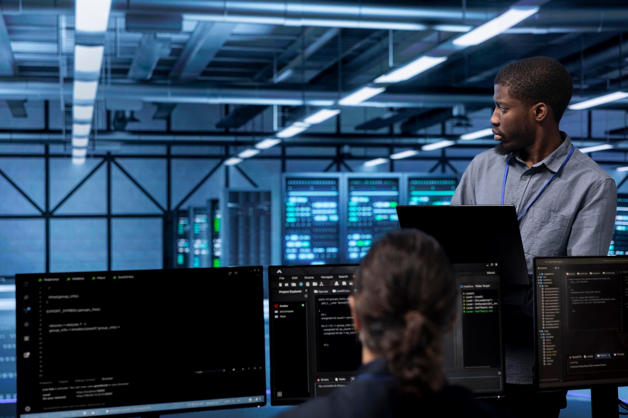 Engineers working at screens in a data centre