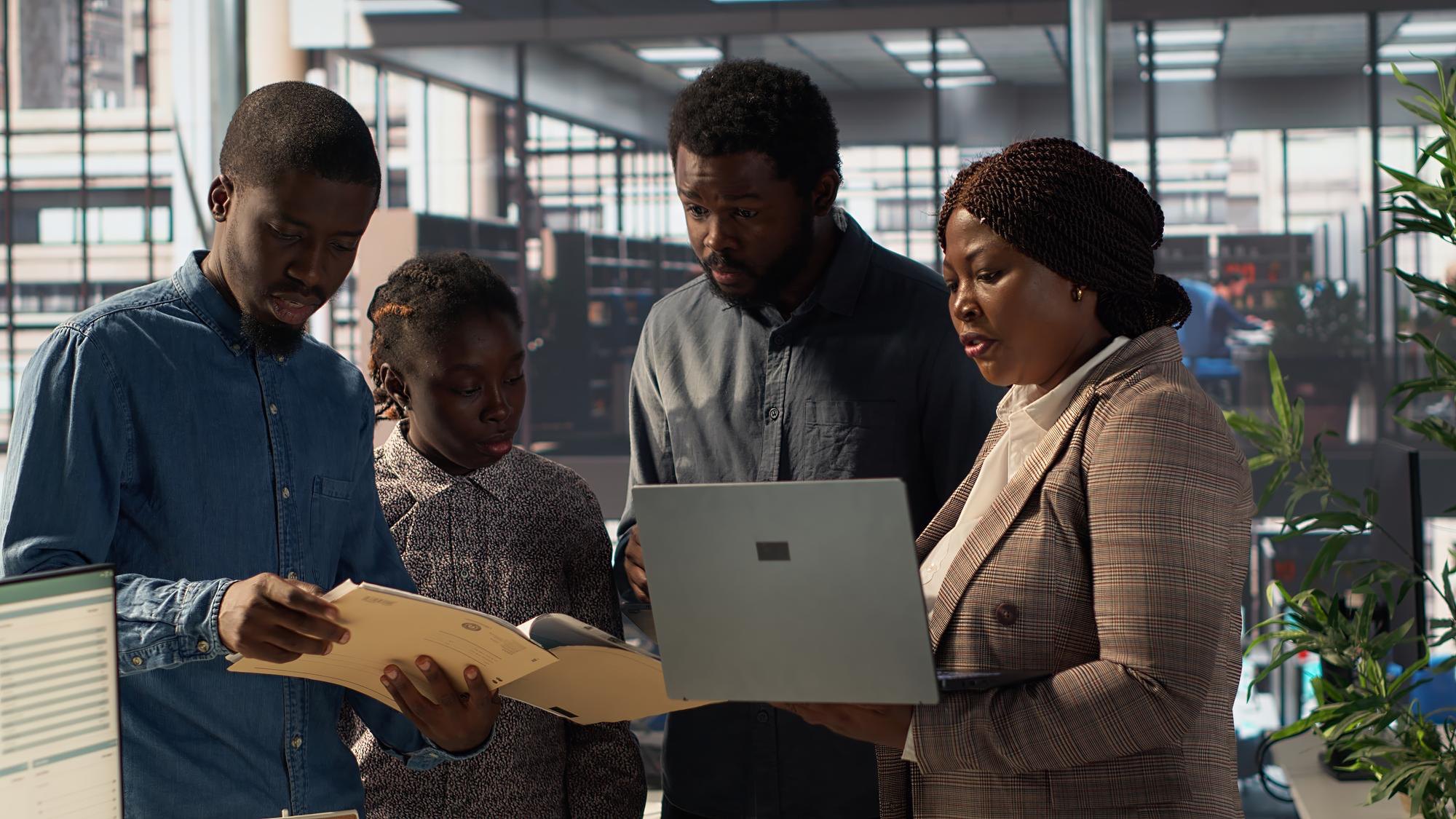 Colleagues working through a document together at a laptop
